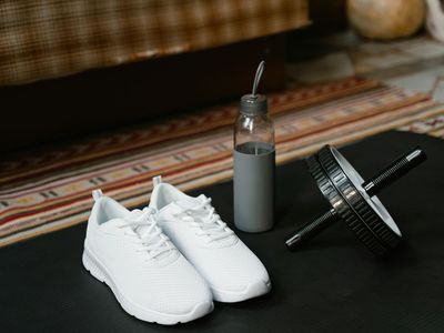 Athletic shoes and a bottle of water on floor