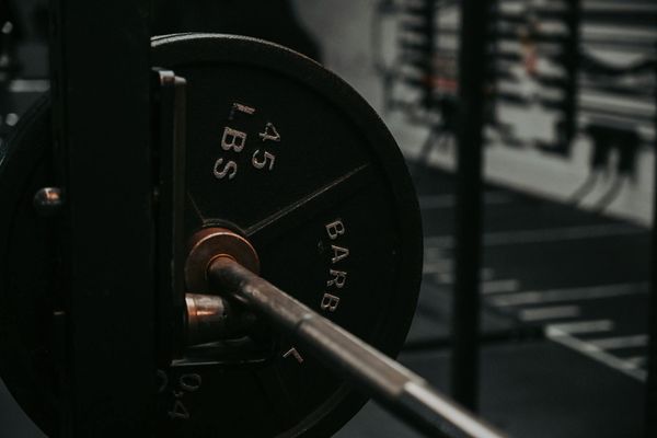Close up of a man training with heavy metal weights