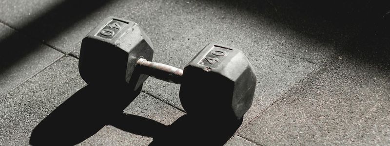 Dumbbells on the floor in a dark fitness studio