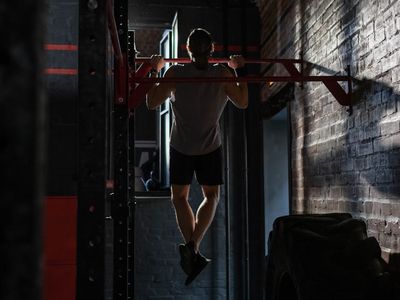Man hands gripping a pull-up bar tightly
